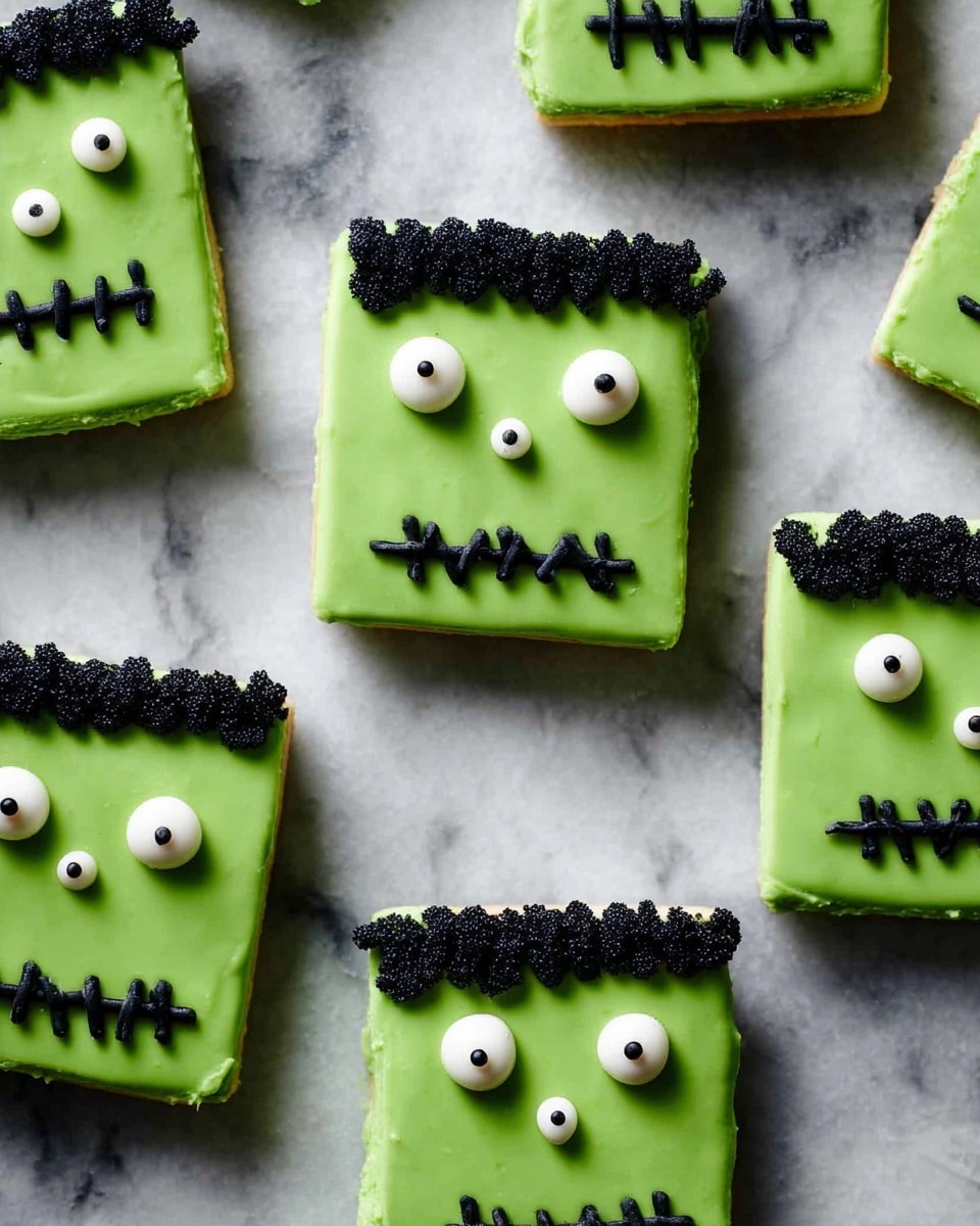The image shows several square green cookies arranged on a white marbled surface. Each cookie has two small round white eyes with black centers near the top. Below the eyes, there is a black zigzag mouth that looks like stitched lines. At the top edge of each cookie, there is also a black wavy line looking like hair. The cookies appear to have two layers: a darker base and a smooth green frosting layer on top. photo taken with an iphone --ar 4:5 --v 7