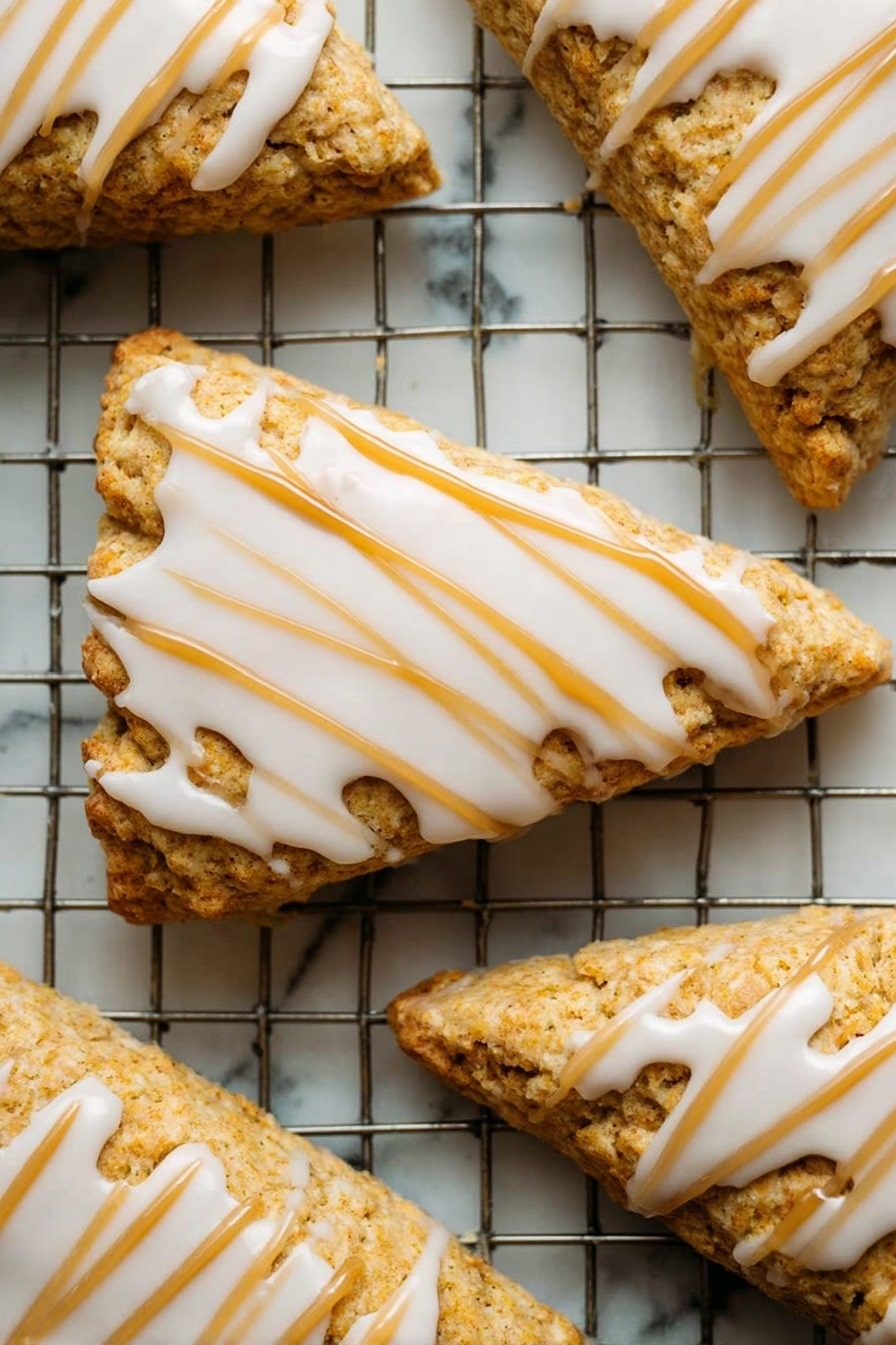 Starbucks Copycat Vegan Pumpkin Scones, vegan pumpkin scones recipe, fall vegan baked goods, vegan pumpkin spice pastries, dairy-free pumpkin scones - A close-up of a single orange-brown bar with a soft, crumbly texture showing a bite taken on one side, topped with a thick layer of smooth, creamy white icing drizzled in parallel lines across the top. The bar is held delicately by a woman's hand with a blurred white marbled background. The focus is on the detailed texture of the bar and the glossy icing with a warm, soft lighting. Photo taken with an iphone --ar 2:3 --v 7