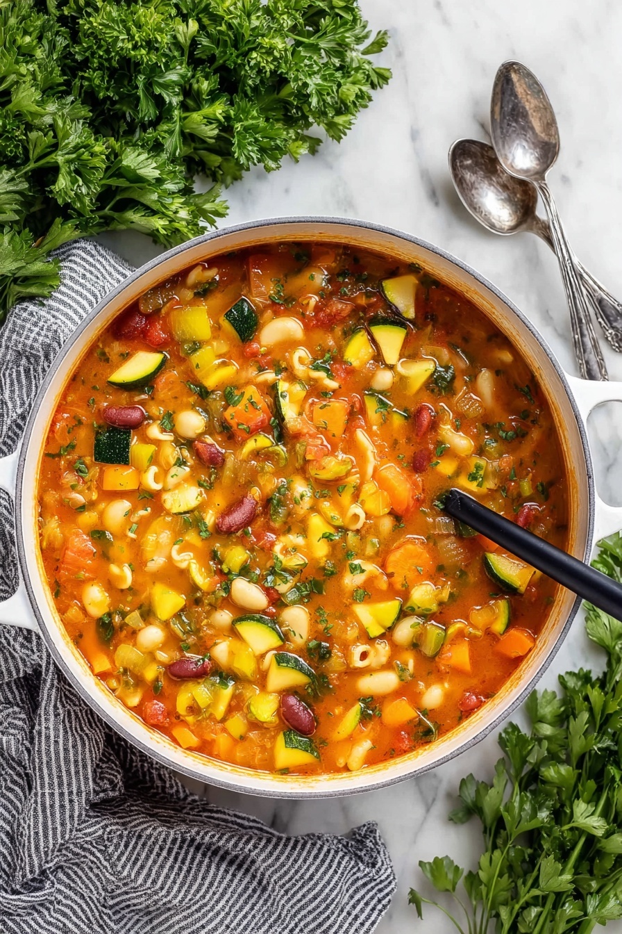 Easy Minestrone Soup, hearty vegetable soup, quick Italian soup, healthy minestrone recipe, comforting veggie soup - A close-up view of a white pot filled with a thick vegetable soup, showing many soft, colorful chunks. The soup has a reddish-orange broth and contains yellow squash, green zucchini slices, orange carrots, celery, red kidney beans, and small shell pasta. A dark wooden ladle lifts a scoop of soup with mixed vegetables and shells, highlighting the varied textures and colors. The pot sits on a white marbled surface with some green herbs blurred in the background, and a woman's hand holding the ladle is slightly visible. Photo taken with an iphone --ar 2:3 --v 7