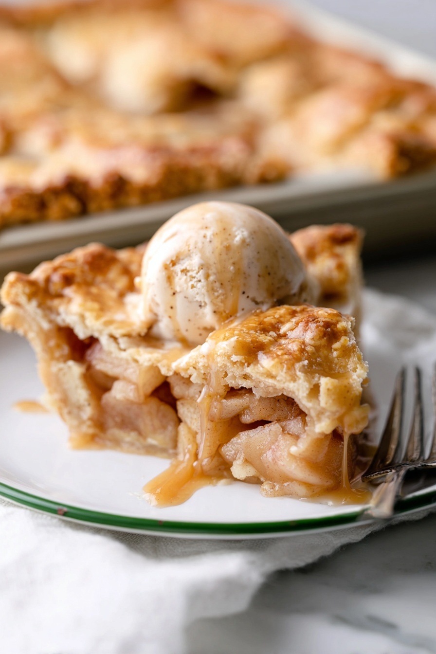 Apple Slab Pie, apple slab pie recipe, easy apple pie dessert, homemade apple slab pie, crowd-pleasing apple pie - A white plate with a green rim holds a slice of apple pie topped with a scoop of cinnamon ice cream. The pie slice has several golden, flaky layers of crust on top and bottom, filled with soft, light brown cooked apple pieces surrounded by a glossy syrup. On the ice cream, dark brown caramel sauce slowly drips down the sides. In the background, part of the remaining pie sits on a baking tray on a white marbled surface, with a silver fork nearby. photo taken with an iphone --ar 2:3 --v 7
