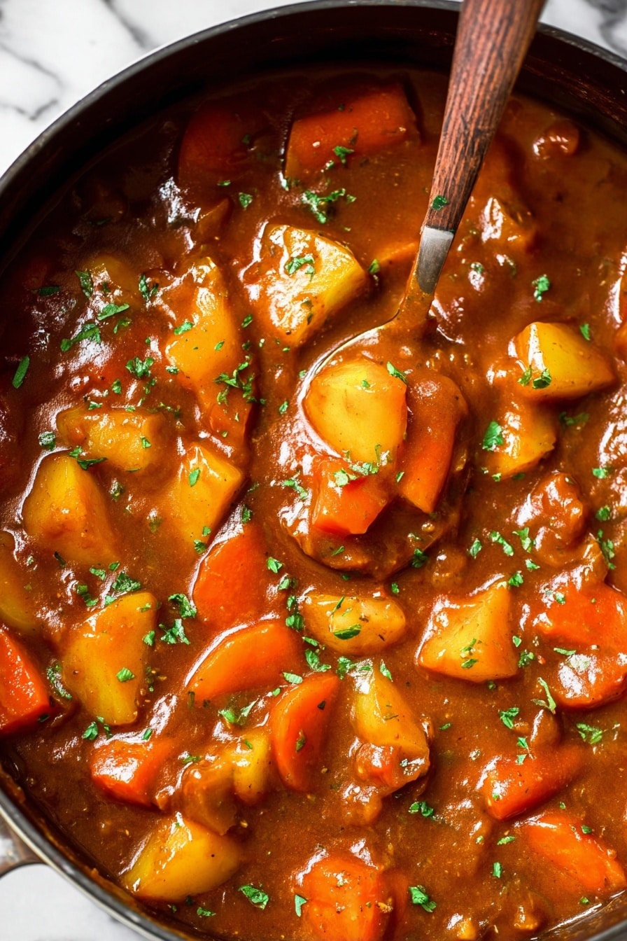 Vegan Irish Stew with Guinness and Gardein Beefless Tips, vegan Irish stew recipe, plant-based Irish stew with Guinness, vegan beefless tips stew, hearty vegan stew recipes - The image shows a thick stew in a large pan filled with chunky vegetables including bright orange carrot slices and yellow potato pieces. The stew sauce is rich brown and glossy, spread evenly around the vegetables. Small green herb pieces sprinkle the top, adding a fresh contrast to the warm tones. A spoon sinks into the stew, lifting some of the colorful vegetables, making the texture appear smooth and hearty. The background surface is a white marbled texture. photo taken with an iphone --ar 2:3 --v 7