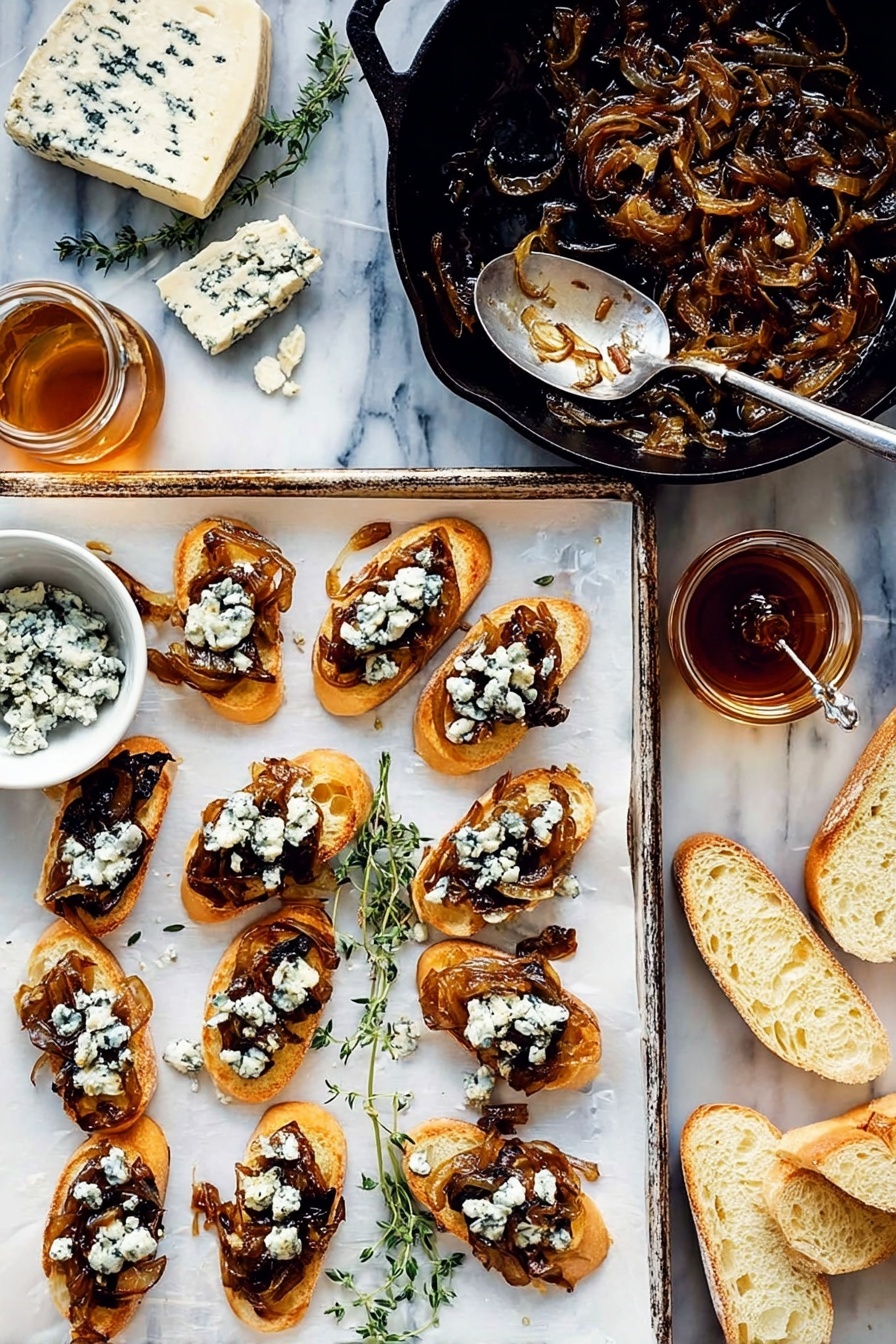 Caramelized Onion Fig Jam Crostini, caramelized onion fig jam appetizer, fig jam crostini with blue cheese, easy appetizer with caramelized onions, gourmet crostini recipes - There is a white baking tray with twelve toasted slices of bread arranged in three rows of four. Each slice has a layer of dark caramelized onions topped with crumbled creamy blue cheese that is white with blue veins. To the right of the tray, there are some plain slices of bread showing a soft, light inside. Above the tray, a black cast iron pan holds more caramelized onions with a silver fork resting inside. On the left side, a wedge of blue cheese and sprigs of fresh herbs sit on the white marbled surface. Below this, a small white bowl contains more blue cheese crumbles, next to a glass jar of dark honey with a spoon inside. Photo taken with an iphone --ar 2:3 --v 7