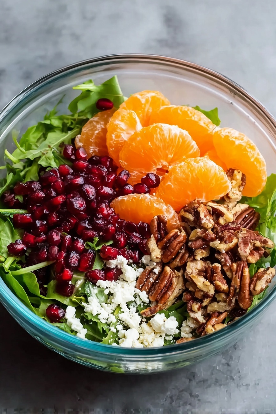 Winter Citrus Salad with Pomegranate and Feta, citrus and pomegranate salad, winter fruit salad, refreshing citrus salad, healthy winter salad - A clear glass bowl filled with four main layers is shown on a white marbled texture. The bottom layer consists of dark green mixed salad leaves covering the base. On top, on the right side, there is a pile of chopped brown pecans with a rough texture. Next to it, slightly to the left, there is a cluster of dark red pomegranate seeds with a shiny, smooth surface. At the front and left side, a thick layer of bright orange peeled tangerine slices with a smooth outer texture is placed. Between the tangerines and pecans, there is a sprinkling of crumbly white cheese with a soft texture. The bowl's transparent sides show the clear separation between each ingredient. Photo taken with an iphone --ar 2:3 --v 7