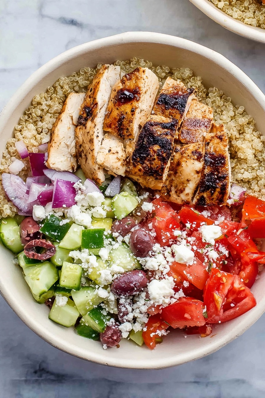 Greek Chicken Quinoa Bowl, Greek Chicken Quinoa Salad, Mediterranean Chicken Bowl, Healthy Quinoa Bowls, Easy Greek Chicken Dinner - A white bowl holds a colorful layered dish on a white marbled surface. The bottom layer is light beige quinoa. On top of this, sliced grilled chicken with visible char marks sits to one side. To the right of the chicken is a mix of chopped red tomatoes and small pieces of red onion. Below the tomato mix is chopped green cucumber with some purple olives scattered throughout. White crumbled cheese is sprinkled over the top of the tomatoes, cucumbers, and olives. The colors contrast well, showing fresh and healthy ingredients. Photo taken with an iphone --ar 2:3 --v 7