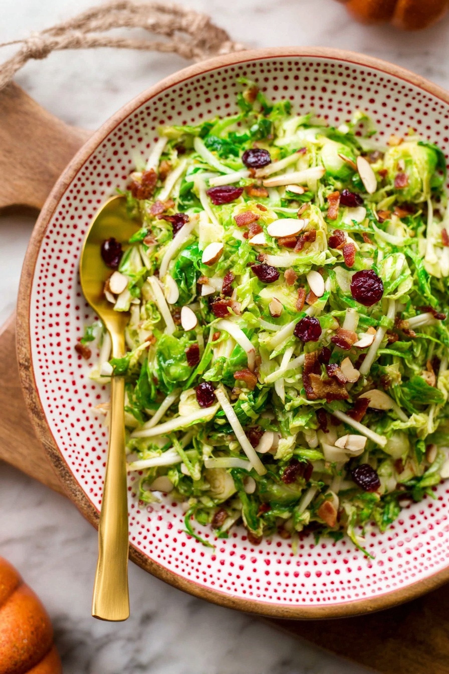 Brussels Sprout Kale Apple Salad, healthy kale and Brussels sprout salad, crunchy apple and kale salad, easy fall salad recipe, vibrant veggie salad - A wooden bowl filled with a shredded green salad showing thin layers of light green and pale yellow textures from the shaved Brussels sprouts. There are visible small pieces of dark red dried cranberries and bits of brown nuts mixed throughout the salad. Bright green leafy bits are scattered across all layers, adding a fresh and crisp look. Two gold forks rest inside the bowl, one leaning on the side. The bowl is placed on a white marbled surface with a few fresh Brussels sprouts and apples nearby, along with part of an orange checkered cloth. Photo taken with an iphone --ar 2:3 --v 7